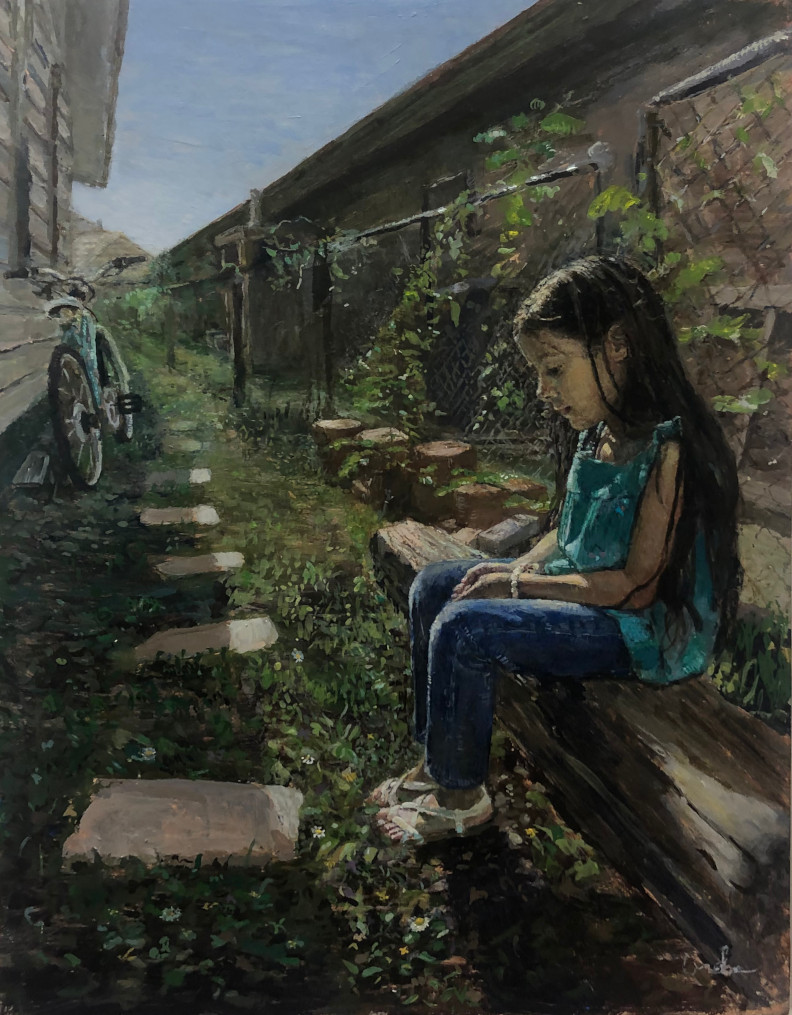 girl seated beside fence